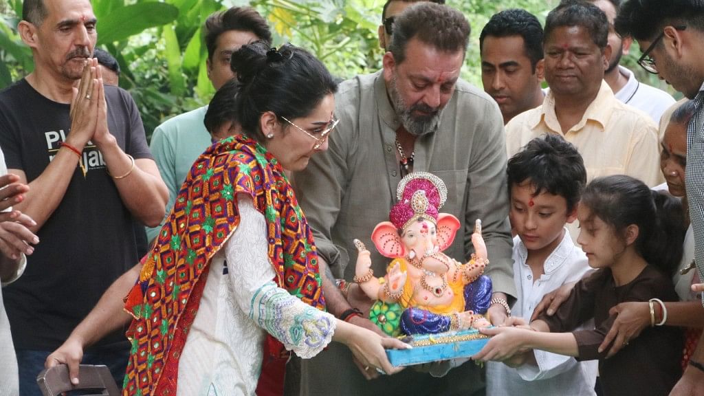 Sanjay Dutt with his family immersing Ganesh idol.