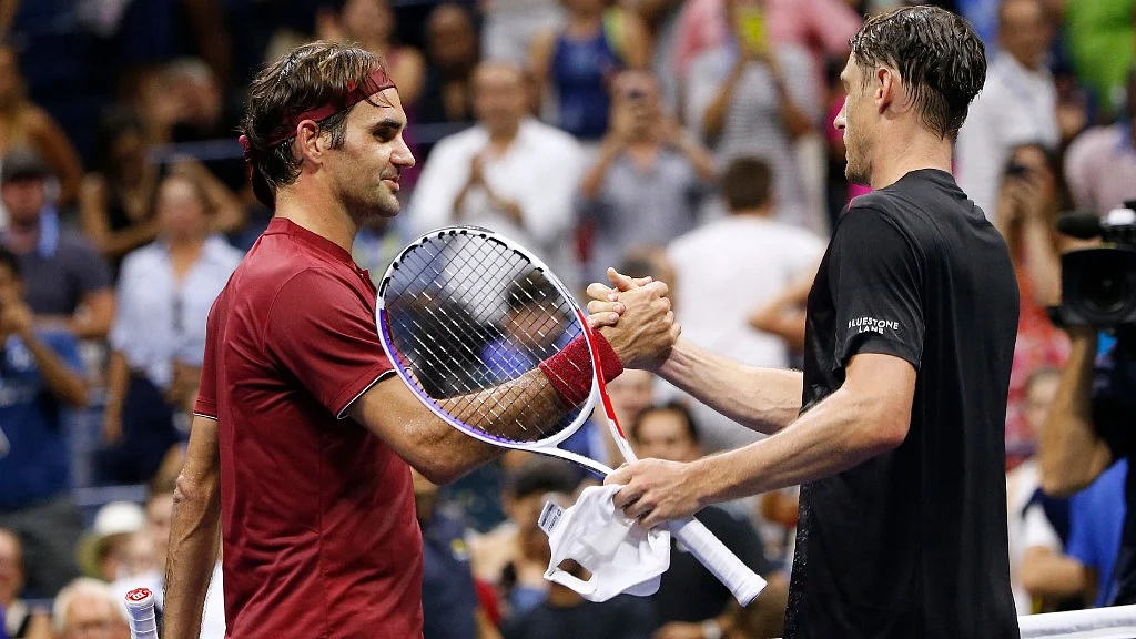 Roger Federer and John Millman after their match.