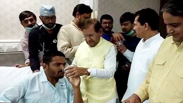 Hardik Patel being offered water by  former Union minister Sharad Yadav.