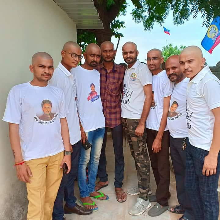 A group of Hardik Patel supporters shave their heads as a mark of solidarity.