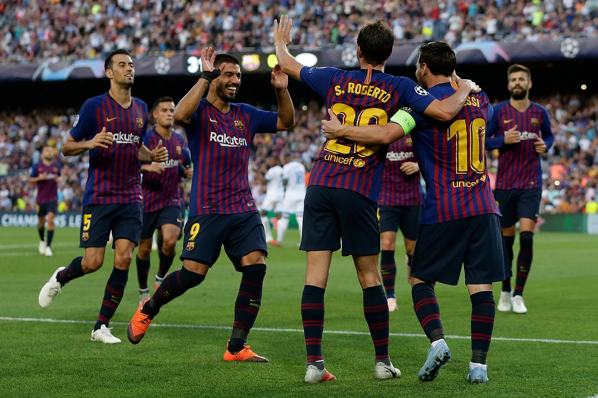 Barcelona players celebrate the opening goal of their team during the group B Champions League soccer match between FC Barcelona and PSV Eindhoven at the Camp Nou stadium in Barcelona, Spain, Tuesday, Sept. 18, 2018. 