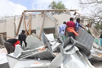 MOGADISHU, Sept. 10, 2018 (Xinhua) -- People search for victims in the wreckage at the scene of suicide attack in Mogadishu, Somalia, Sept. 10, 2018. At least six people were killed and 16 others injured in a suicide car bombing targeting Mogadishu
