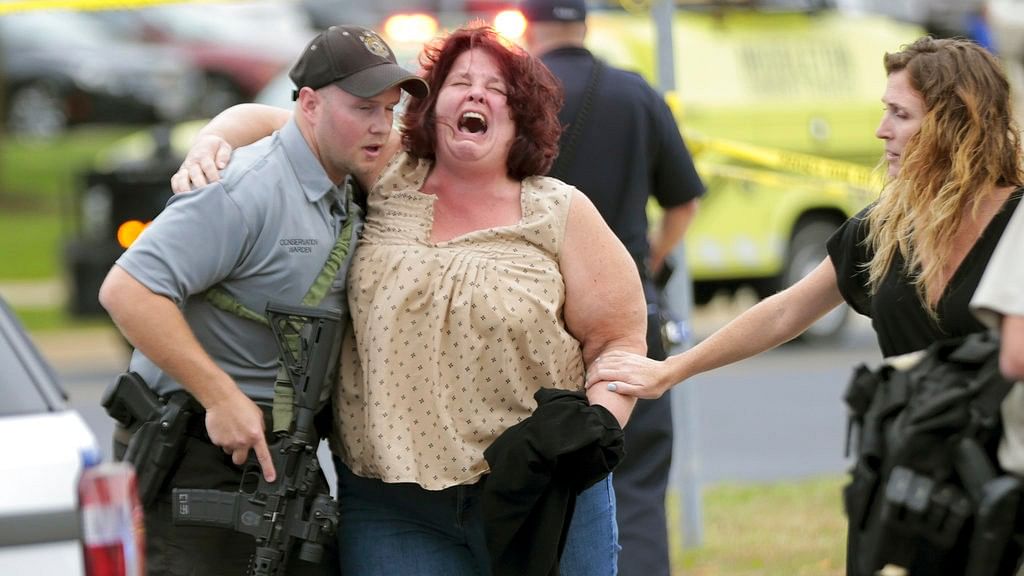 A woman is escorted from the scene of a shooting at a software company in Middleton, Wisconsin on Wednesday, 19 September, 2018.