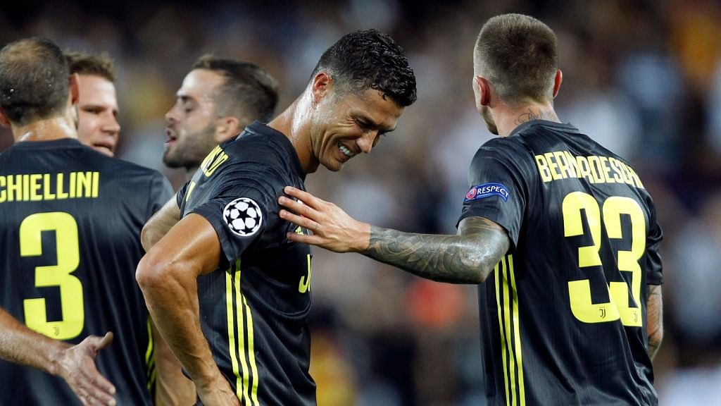 Juventus forward Cristiano Ronaldo is consoled by teammate Federico Bernardeschi after receiving a red card during the Champions League match against Valencia on Wednesday.&nbsp;