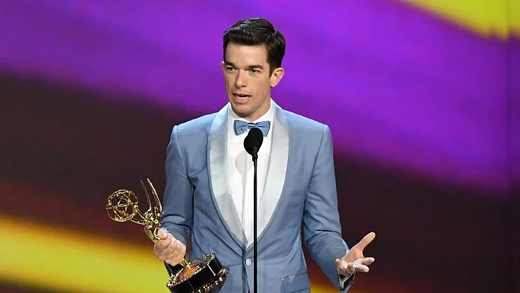 John Mulaney with his award. 