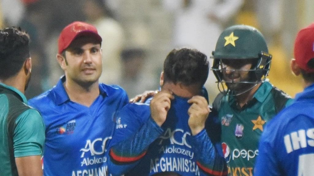 Pakistan’s Shoaib Malik trying to console Afghanistan’s Aftab Alam after his side lost by 3 wickets to Pakistan in the Super Four match of the Asia Cup on Friday.