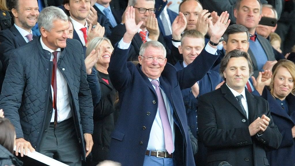 Former Manchester United manager Alex Ferguson waves as he takes his seat in the stands before the English Premier League match against Wolverhampton Wanderers at Old Trafford  in Manchester on Saturday.&nbsp;