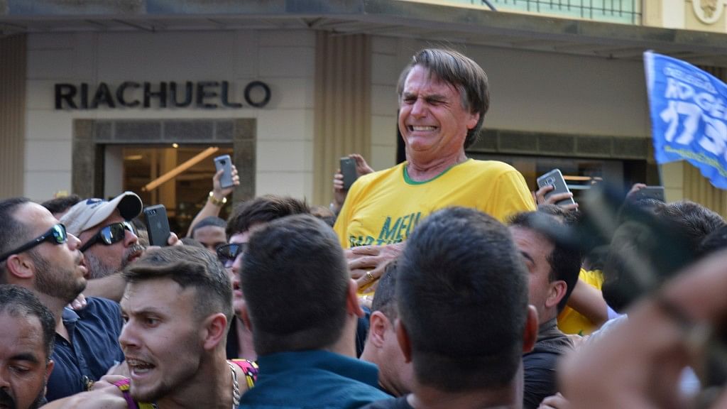 Presidential candidate Jair Bolsonaro grimaces right after being stabbed in the stomach during a campaign rally in Juiz de Fora, Brazil.