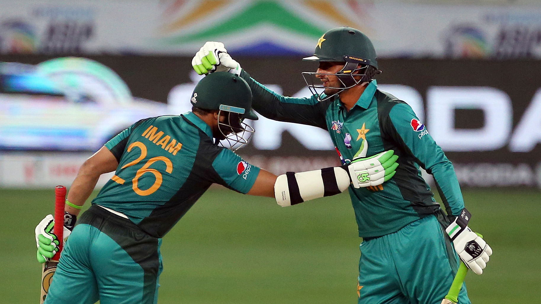 Pakistan’s Shoaib Malik, right, congratulates teammate Imam-ul-Haq on scoring a fifty runs during the one day international cricket match of Asia Cup between Pakistan and Hong Kong in Dubai, United Arab Emirates, Sunday, Sept. 16, 2018.&nbsp;