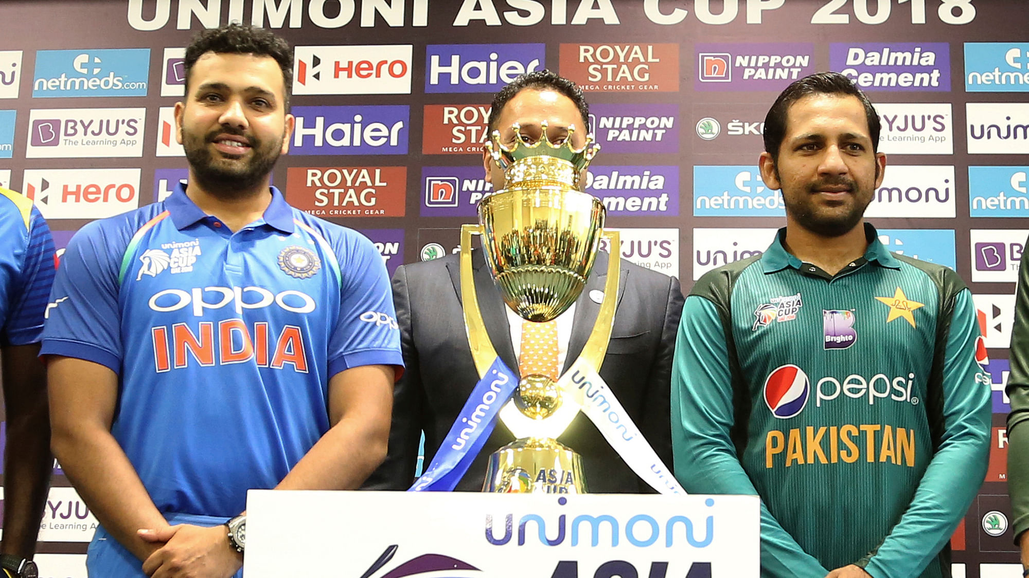 Captains of India Rohit Sharma, left, and Pakistan Sarfraz Ahmed pose with the winners trophy before the start of the Asia Cup. The two teams will face off on Tuesday in Dubai.