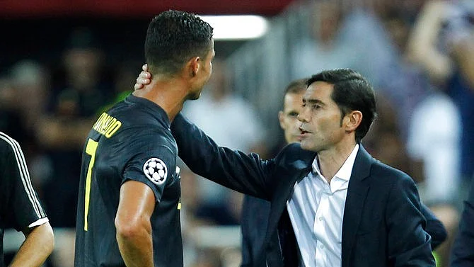 Juventus’ Cristiano Ronaldo is consoled by Valencia coach Marcelino Garcia as he walks off the pitch after getting a red card during the Champions League match against Valencia on Wednesday.