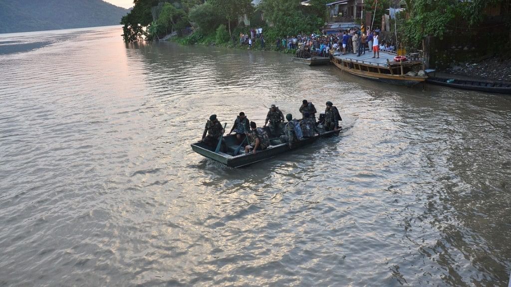 Indian Army personnel carry out a search operation after a boat carrying 36 passengers capsized in the Brahmaputra river at Aswalakanta in Kamrup district of Assam, Wednesday, 5 September, 2018