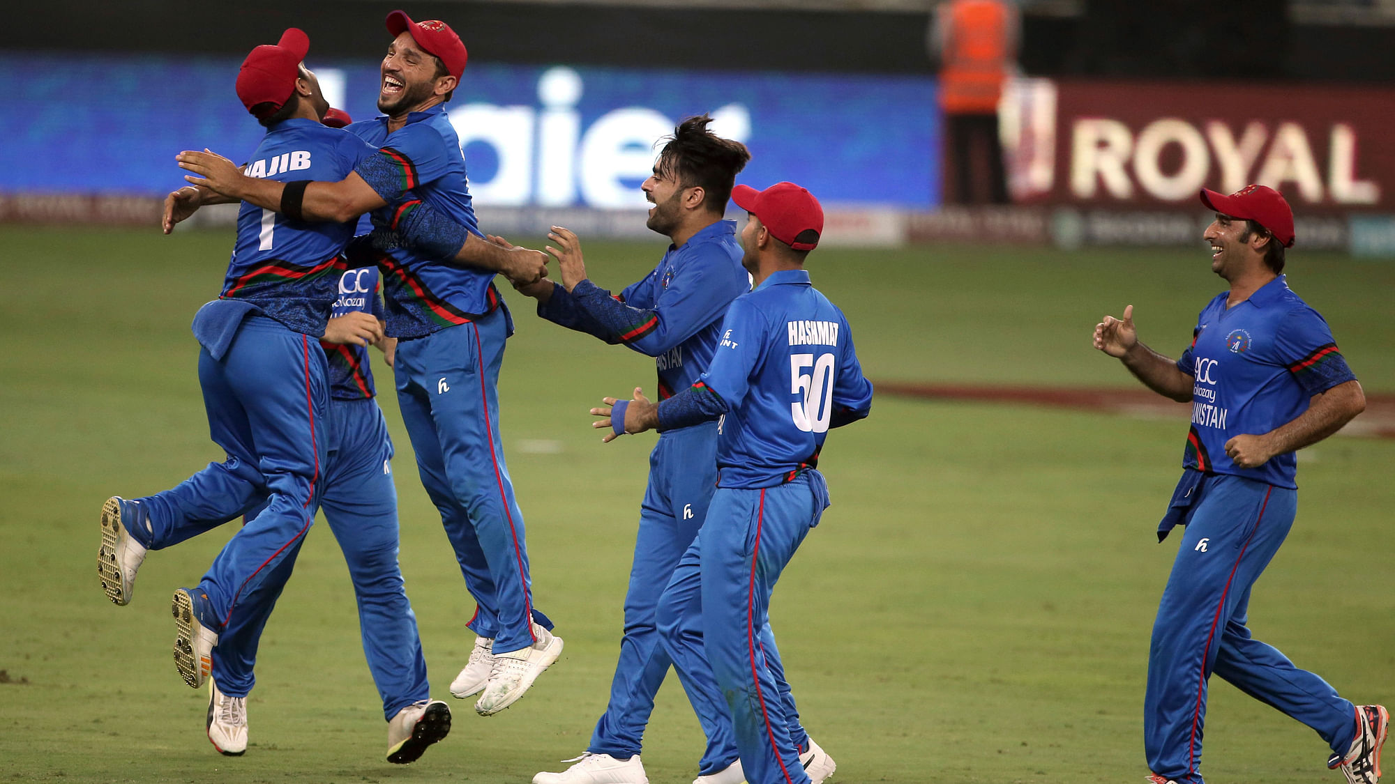 Afghanistan cricketers celebrate after drawing with India in their final Super Four match.