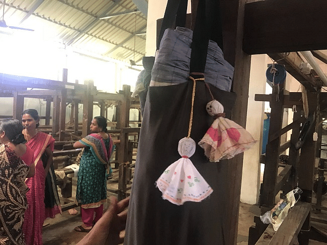 The dolls are made from the garments that were soiled and destroyed during to floods.