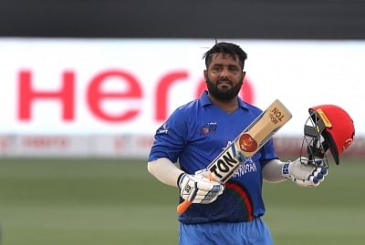 Dubai: Mohammad Shahzad of Afghanistan celebrates his century during the fifth match of Asia Cup 2018 Super Four between India and Afghanistan at Dubai International Cricket Stadium in Dubai, UAE on Sept 25, 2018. (Photo: Surjeet Yadav/IANS)