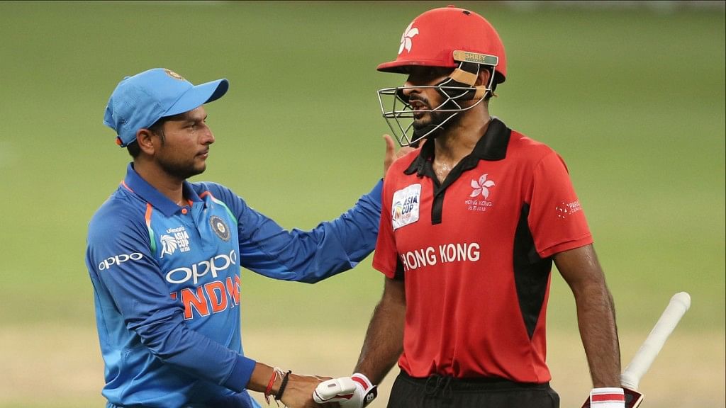 Kuldeep Yadav congratulating a Hong Kong player.