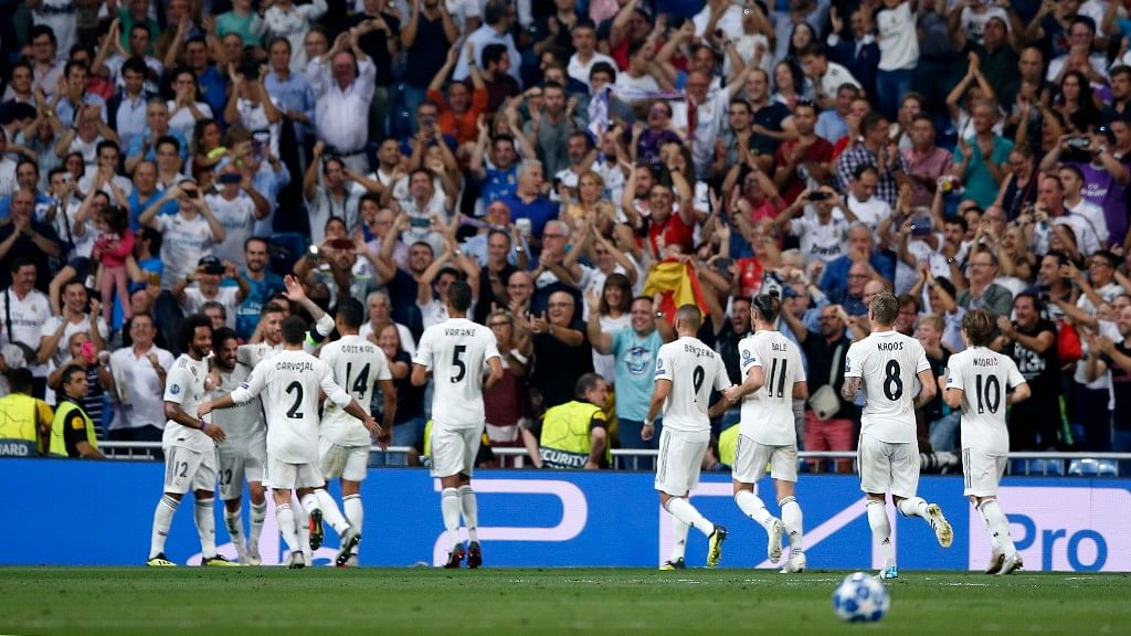 Real midfielder Isco celebrates with teammates after scoring his side’s opening goal during their  Champions League match against Roma in Madrid on Wednesday.