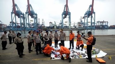 JAKARTA, Oct. 30, 2018 (Xinhua) -- Indonesian Search and Rescue (SAR) members and police officers check belongings of Lion Air Flight JT 610 victims at Jakarta International Container Terminal (JICT) in Tanjung Priok, Jakarta, Indonesia, on Oct. 30, 2018. Rescuers have retrieved 24 bags of body parts after a Lion Air plane with 189 people aboard crashed into sea off western Indonesia, the low-cost carrier said on Tuesday.  (Xinhua/Agung Kuncahya B/IANS)