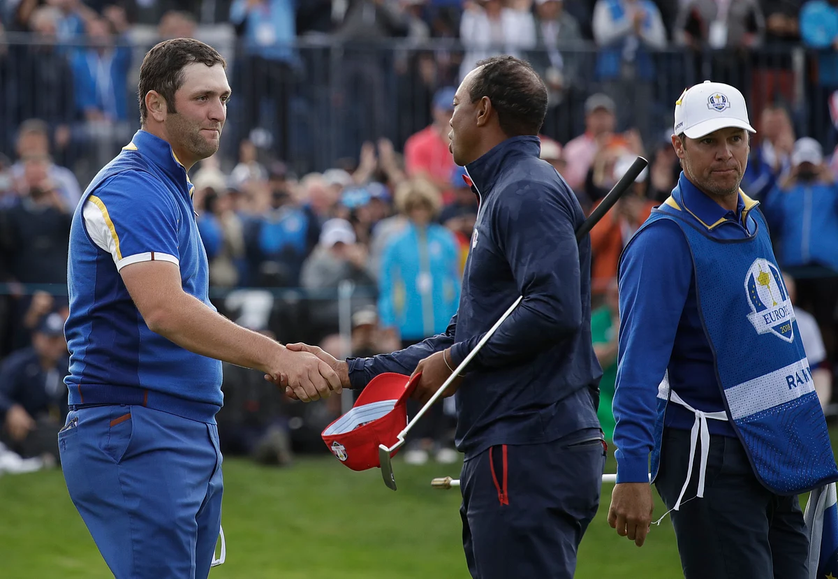 Europe’s Jon Rahm, left, shakes hands with Tiger Woods of the US after beating them in a singles match on the final day of the 42nd Ryder Cup. 