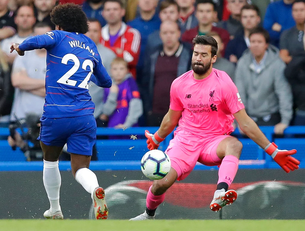 Liverpool’s goalkeeper Alisson Becker makes a save during the Premier League match against Chelsea.