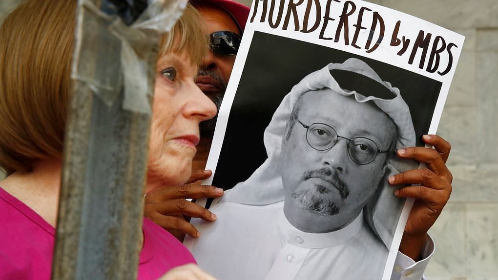  In this 10 October, 2018, file photo, people hold signs during a protest at the Embassy of Saudi Arabia about the disappearance of Saudi journalist Jamal Khashoggi, in Washington. 