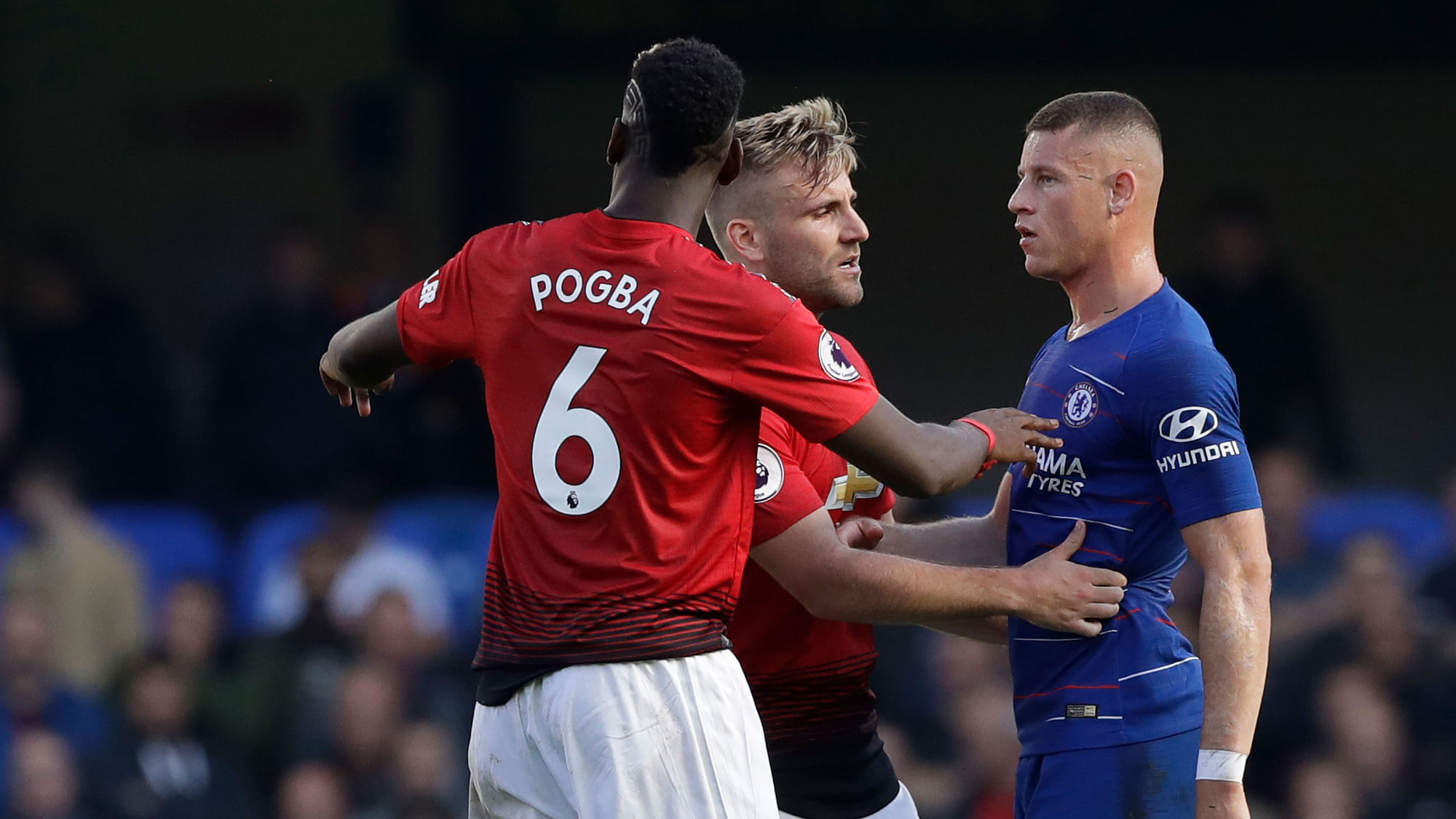 ManU defender Luke Shaw, center and Paul Pogba argue with Chelsea’s Ross Barkley, right, after he scored his side’s second goal.