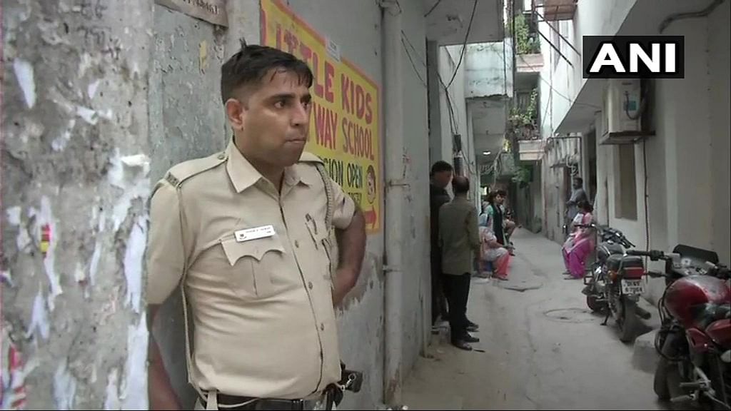 Police stands infront of the house in Vasant Kunj where the three bodies were found.