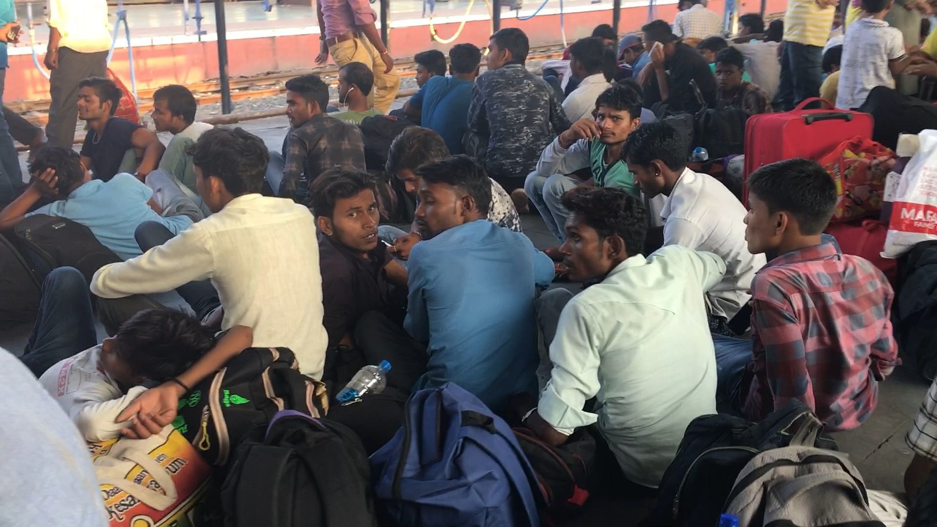 Migrant workers wait for their train at Ahmedabad Railway Station.