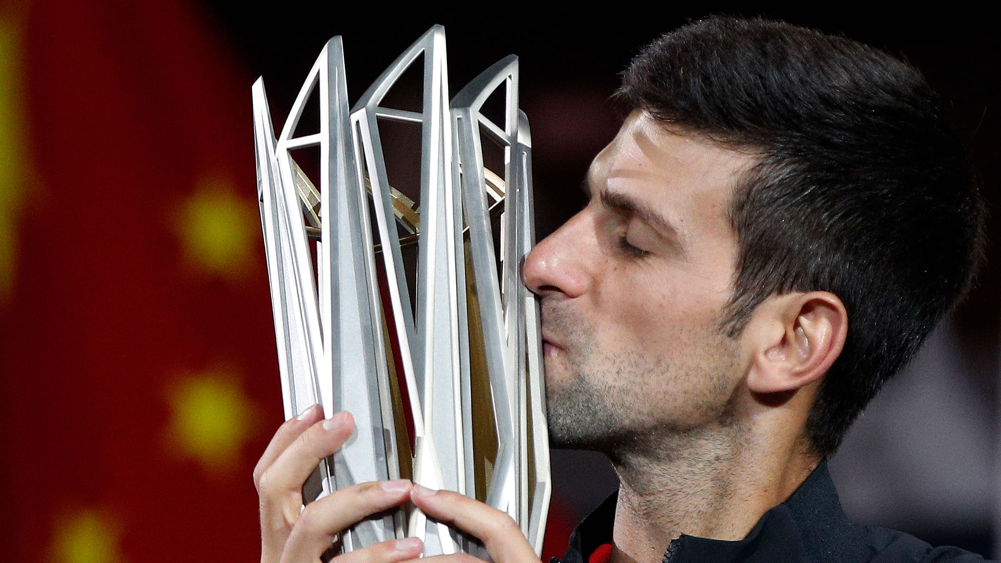 Novak Djokovic of Serbia kisses his trophy after defeating Borna Coric of Croatia in their men’s singles final match to win the Shanghai Masters tennis tournament.