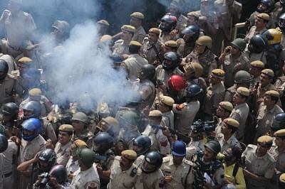 New Delhi: Police fire tear gas shells to disperse protesting farmers at the Uttar Pradesh-Delhi border on Oct 2, 2018. The protest by thousands of farmers turned violent as they tried to break barricades and run them over with tractors to enter the national capital. The police action led to several injuries while one of the protestors lost consciousness. The farmers, who were marching to Delhi from Haridwar under the banner of Kisan Kranti Yatra demanding complete loan waiver and reduction in e