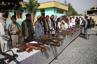 NANGARHAR, Oct. 10, 2018 (Xinhua) -- Taliban fighters attend a surrender ceremony in Bati Kot district of Nangarhar province, Afghanistan, on Oct. 10, 2018. About 75 Taliban rebels renounced violence and surrendered to the government in Afghanistan