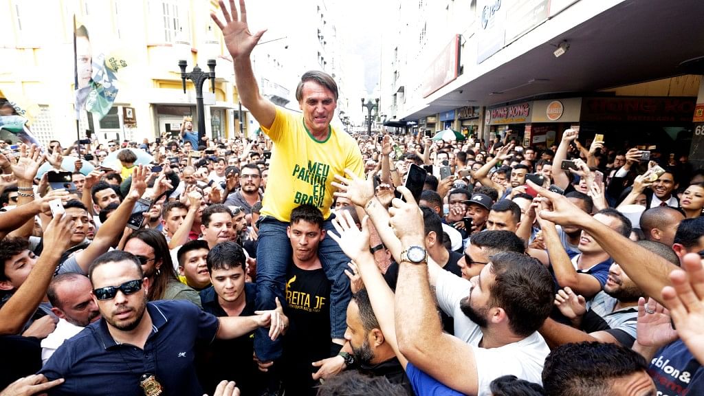 Presidential candidate Jair Bolsonaro is taken on the shoulders of a supporter moments before he was stabbed during a campaign rally in Juiz de Fora, Brazil.