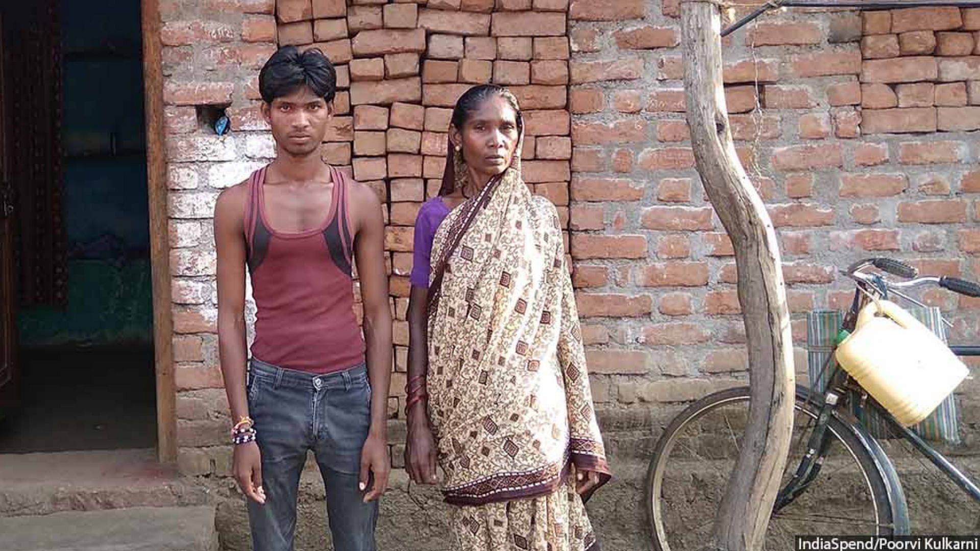 Rekha Madavi, 45, and her youngest son, Bhimrao, 25, outside their house in Chak Mankapur, an adivasi village in eastern Maharashtra’s Chandrapur district.