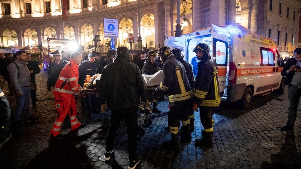 Firefighters evacuate a person who was wounded after an escalator at the “Repubblica” subway station in Rome, started running much too fast before crashing.
