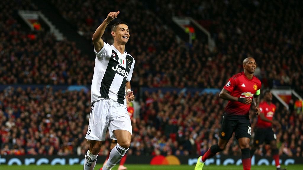 Juventus forward Cristiano Ronaldo gestures to a teammate during the Champions League group H soccer match between Manchester United and Juventus at Old Trafford, Manchester, England.