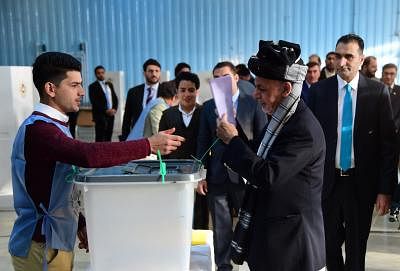 KABUL, Oct. 20, 2018 (Xinhua) -- Afghan President Ashraf Ghani (R, front) casts his ballot at a polling center during parliamentary elections in Kabul, Afghanistan, Oct. 20, 2018. Millions of Afghan voters cast their ballots on Saturday for long-delayed parliamentary elections in the militancy-plagued country amid reports of security threats and irregularities. (Xinhua/Dai He/IANS)
