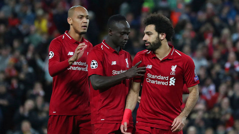 Liverpool forward Mohamed Salah, right celebrates with teammates after scoring his side’s third goal against Red Star.