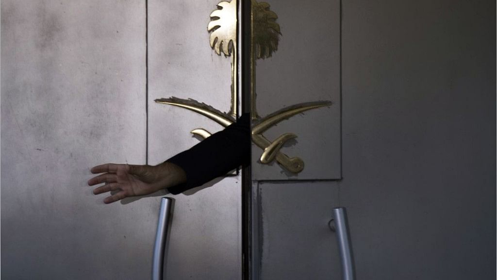 A security guard reaches out his hand from the entrance of the Saudi Arabia’s consulate in Istanbul, Turkey.&nbsp;