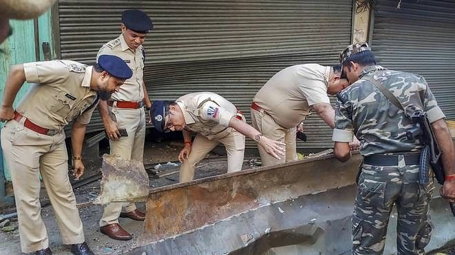 Police inspecting the area outside the building, at Nagerbazar in Kolkata’s Dum Dum, where the blast took place.&nbsp;