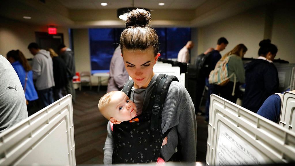 Kristen Leach votes with her six-month-old daughter, Nora, on election day in Atlanta, Tuesday, 6 November.&nbsp;
