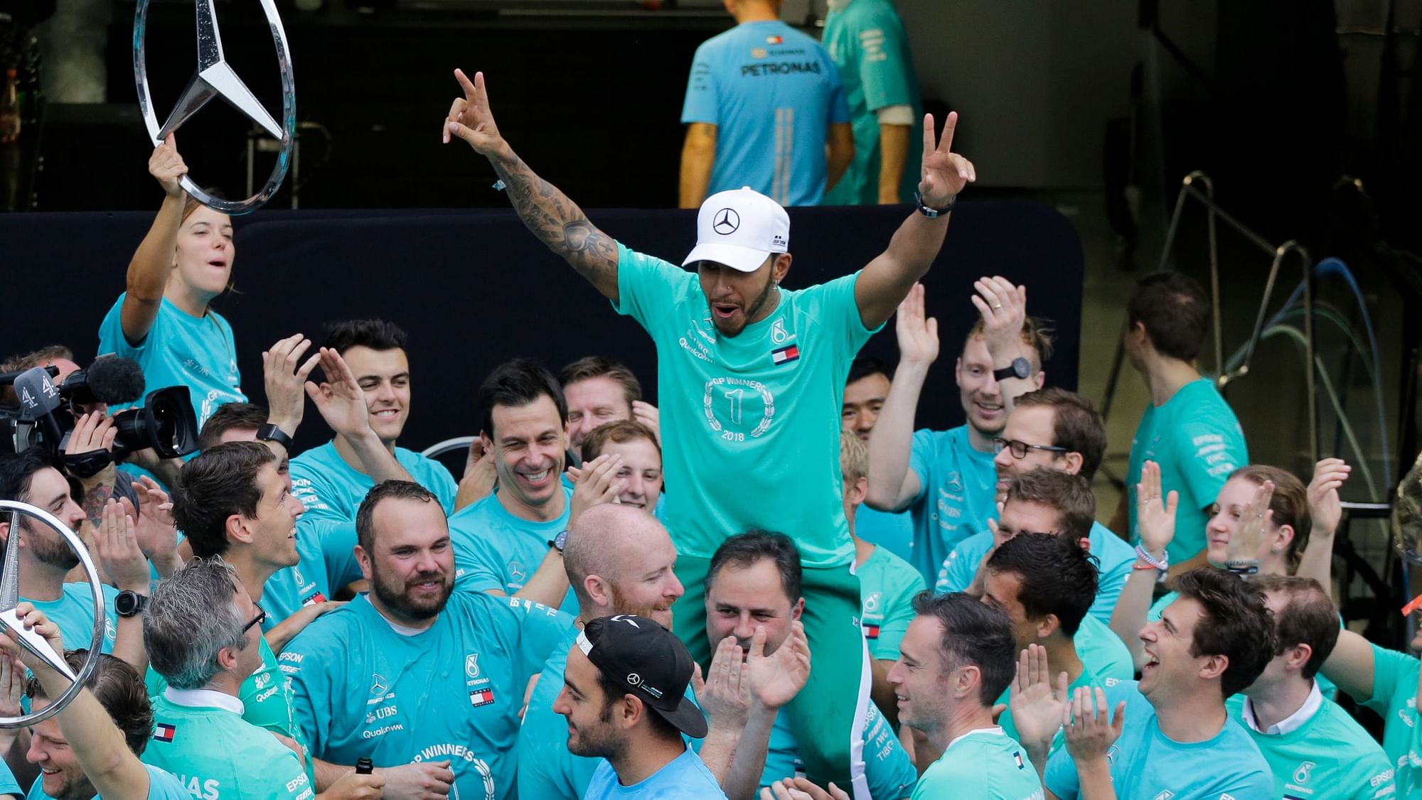Lewis Hamilton and Team Mercedes celebrate after the Brazilian Grand Prix