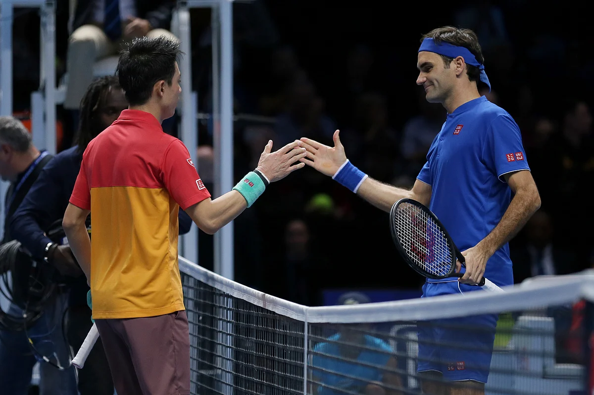 Nishikori and Federer shake hands at the end of their Group Hewitt clash in London