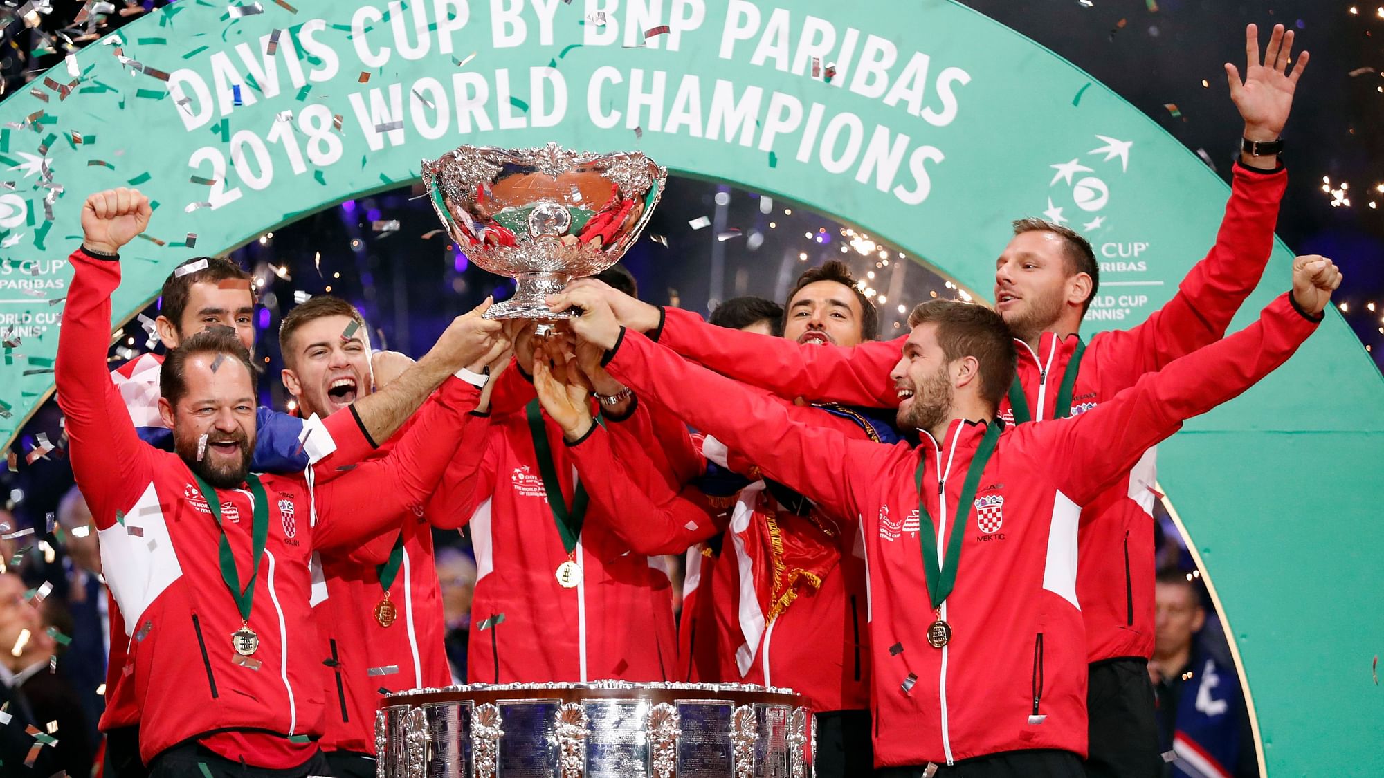 Croatia’s team captain Zeljko Krajan (left) and players lift up the cup after the team won the Davis Cup final between France and Croatia in 2018.