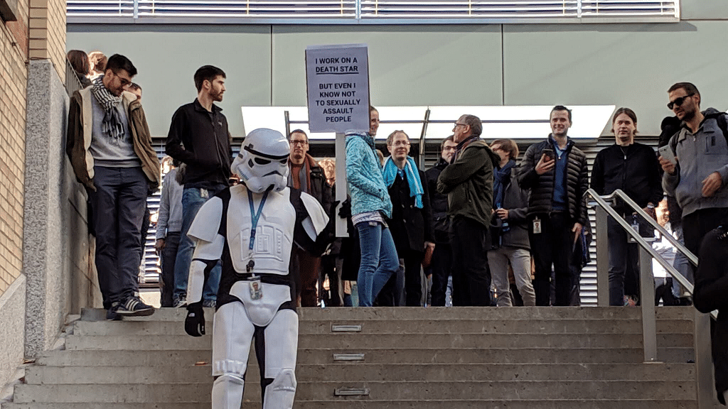 During Google employees’ walkout in Zurich, a person was seen wearing a storm trooper costume, holding a placard that read “even I know not to sexually assault people.”