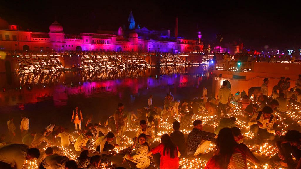 Devotees light earthen lamps on the banks of the River Sarayu as part of Diwali celebrations in Ayodhya.