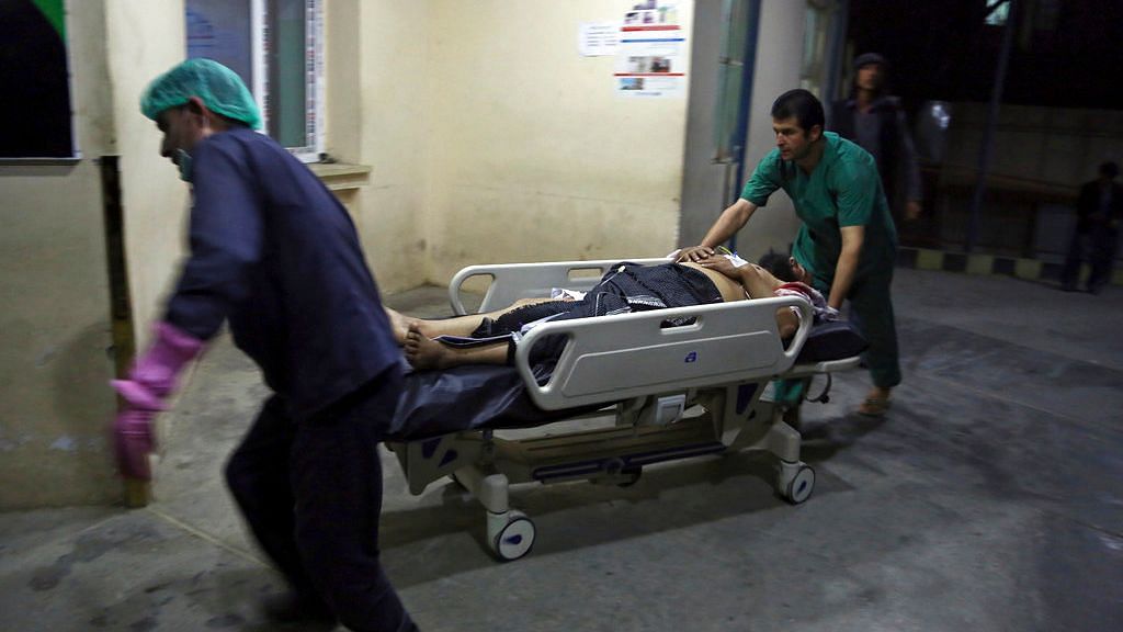 A man injured in a suicide bombing is brought into a hospital in Kabul, Afghanistan, on 20 November.