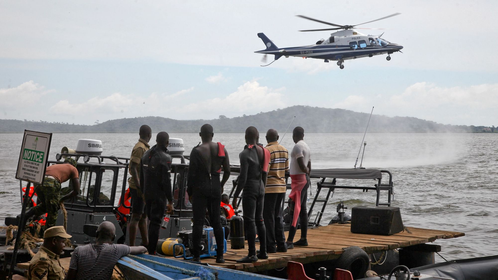 A helicopter searches for victims of a boat which capsized in Lake Victoria.