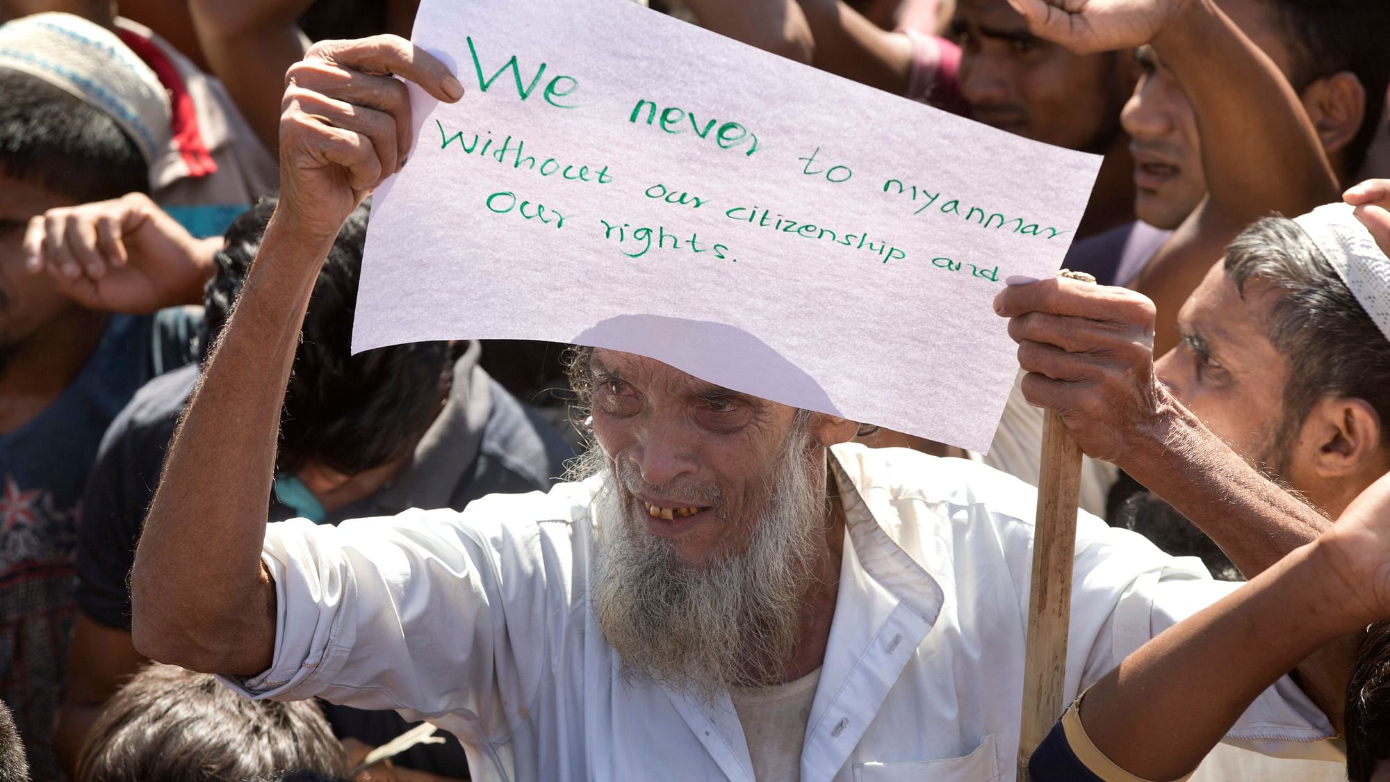 An elderly Rohingya refugee holds a placard during a protest against the repatriation process at Unchiprang refugee camp near Cox’s Bazar, in Bangladesh