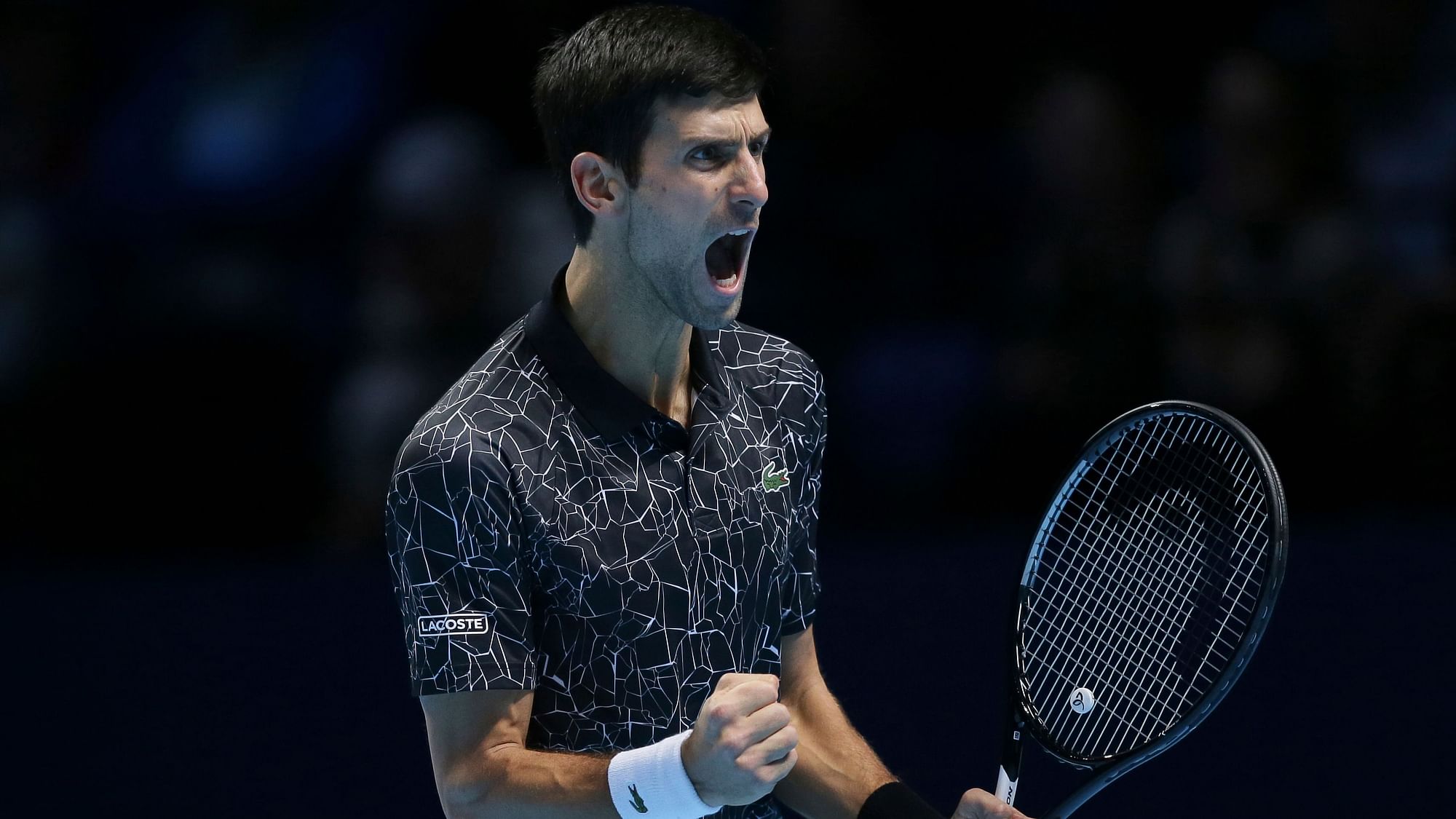 Novak Djokovic celebrates a point during his ATP Finals opener against John Isner