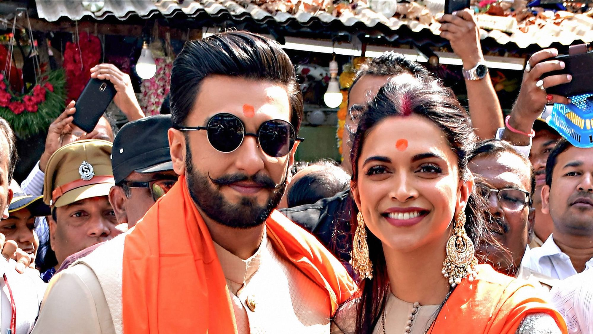 Newly-wed Bollywood actors Deepika Padukone and Ranveer Singh pose for photos on their visit to Siddhivinayak Temple, in Mumbai, Friday, Nov. 30, 2018.